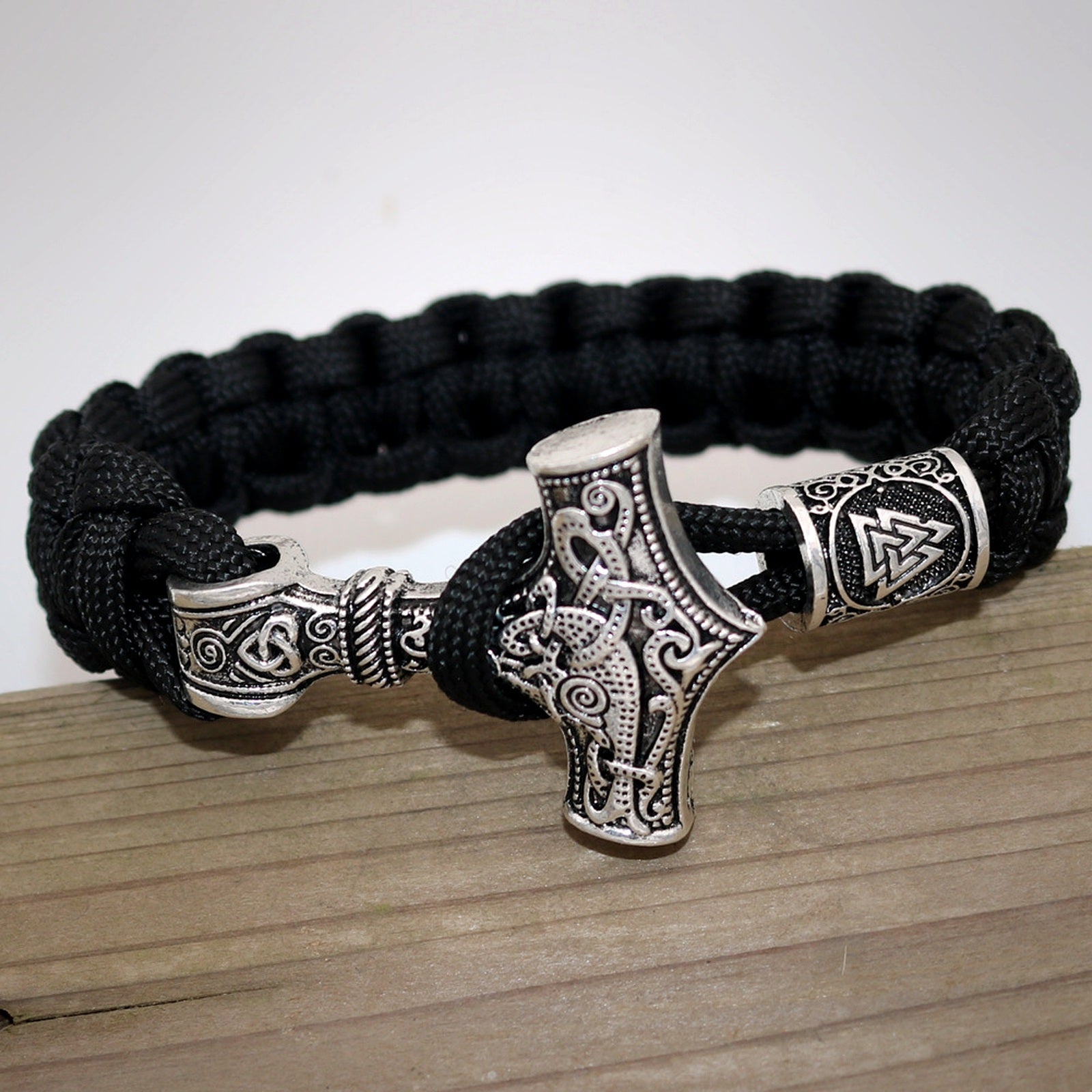Aegis Wolf Helm of Awe cord bracelet on dark wood