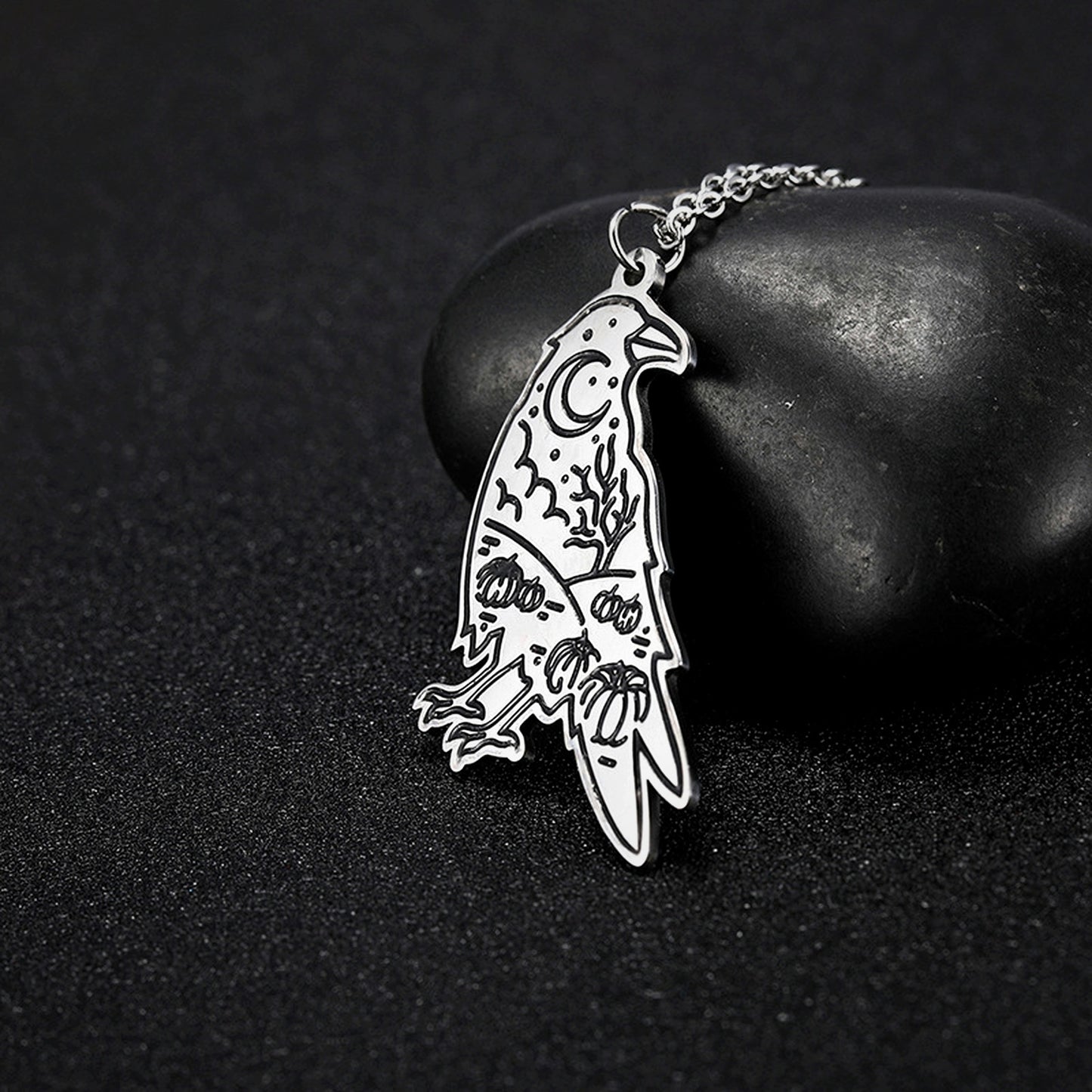 Hugin Moon raven insight pendant on dark stone