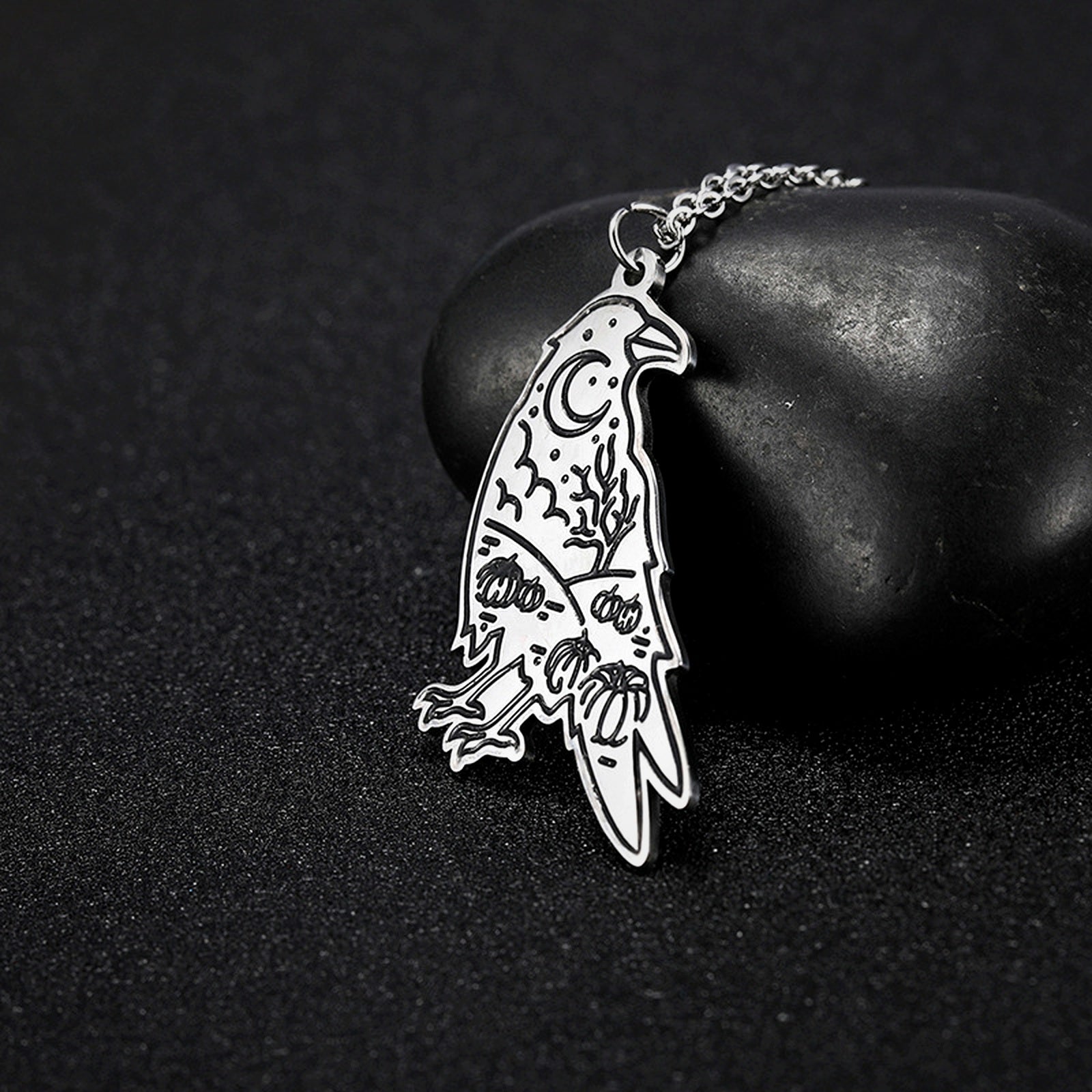 Hugin Moon raven insight pendant on dark stone
